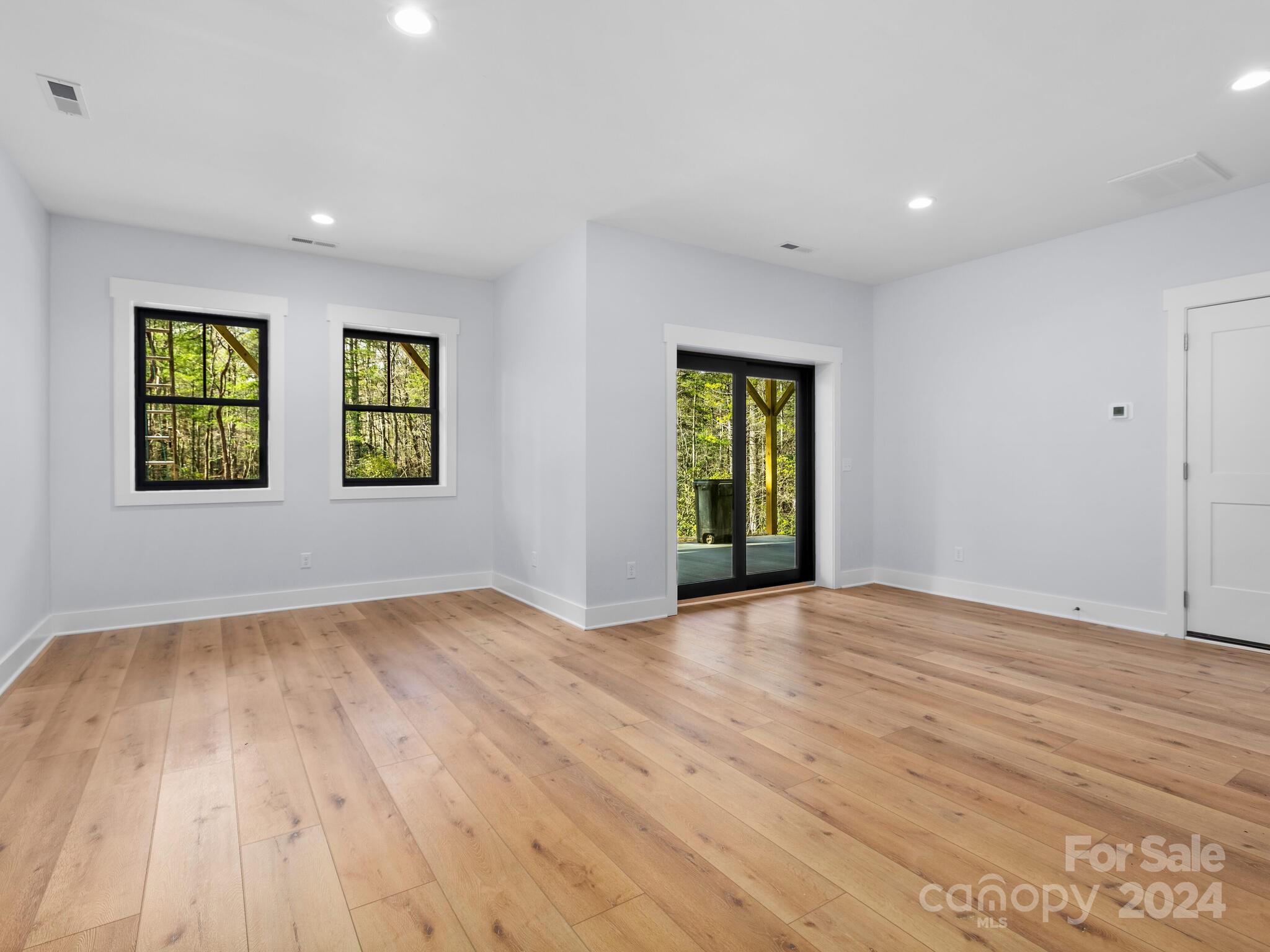 70 Reta Road Fairview, NC 28730 - Photo 19 of 22 a view of an empty room with wooden floor and a window