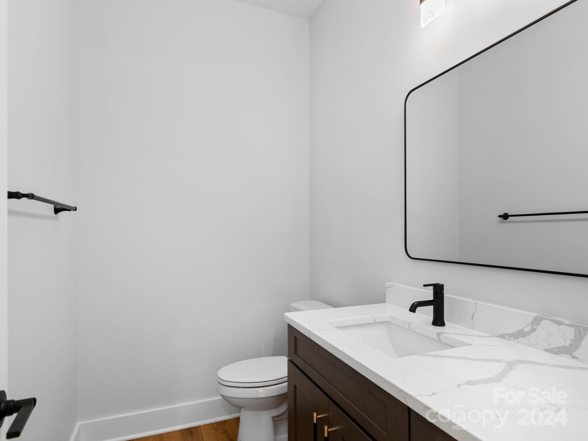70 Reta Road Fairview, NC 28730 - Photo 20 of 22 a bathroom with a granite countertop sink toilet and mirror