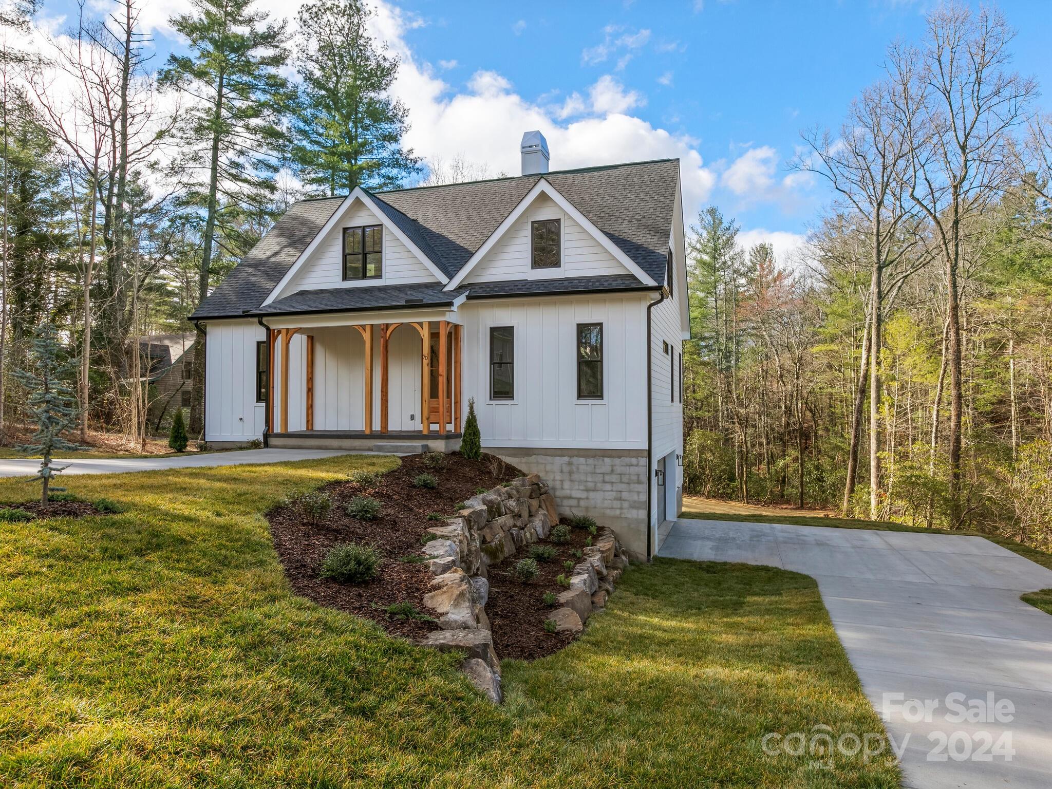 70 Reta Road Fairview, NC 28730 - Photo 2 of 22 a front view of a house with garden