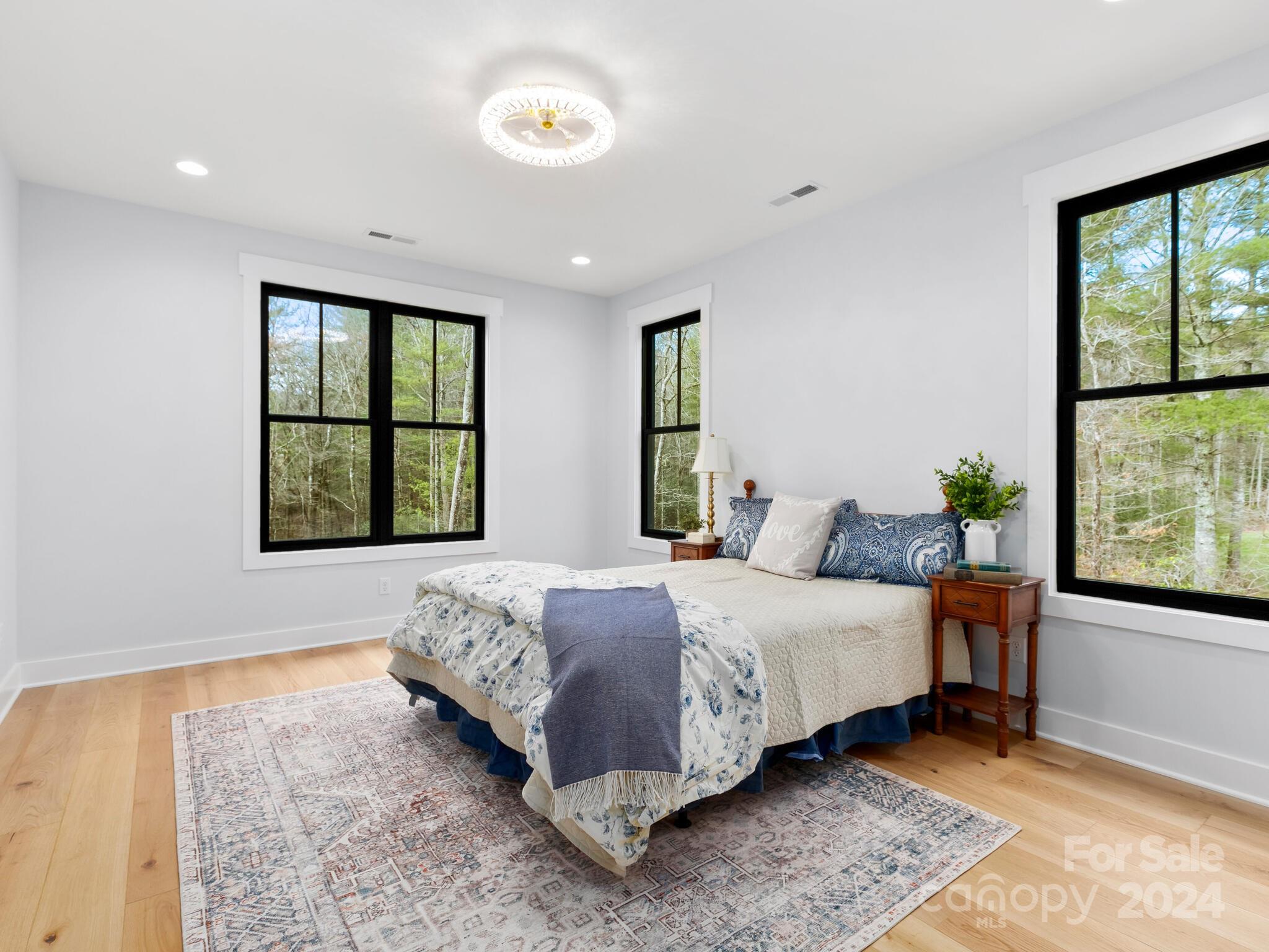 70 Reta Road Fairview, NC 28730 - Photo 9 of 22 a bedroom with a bed next to a window