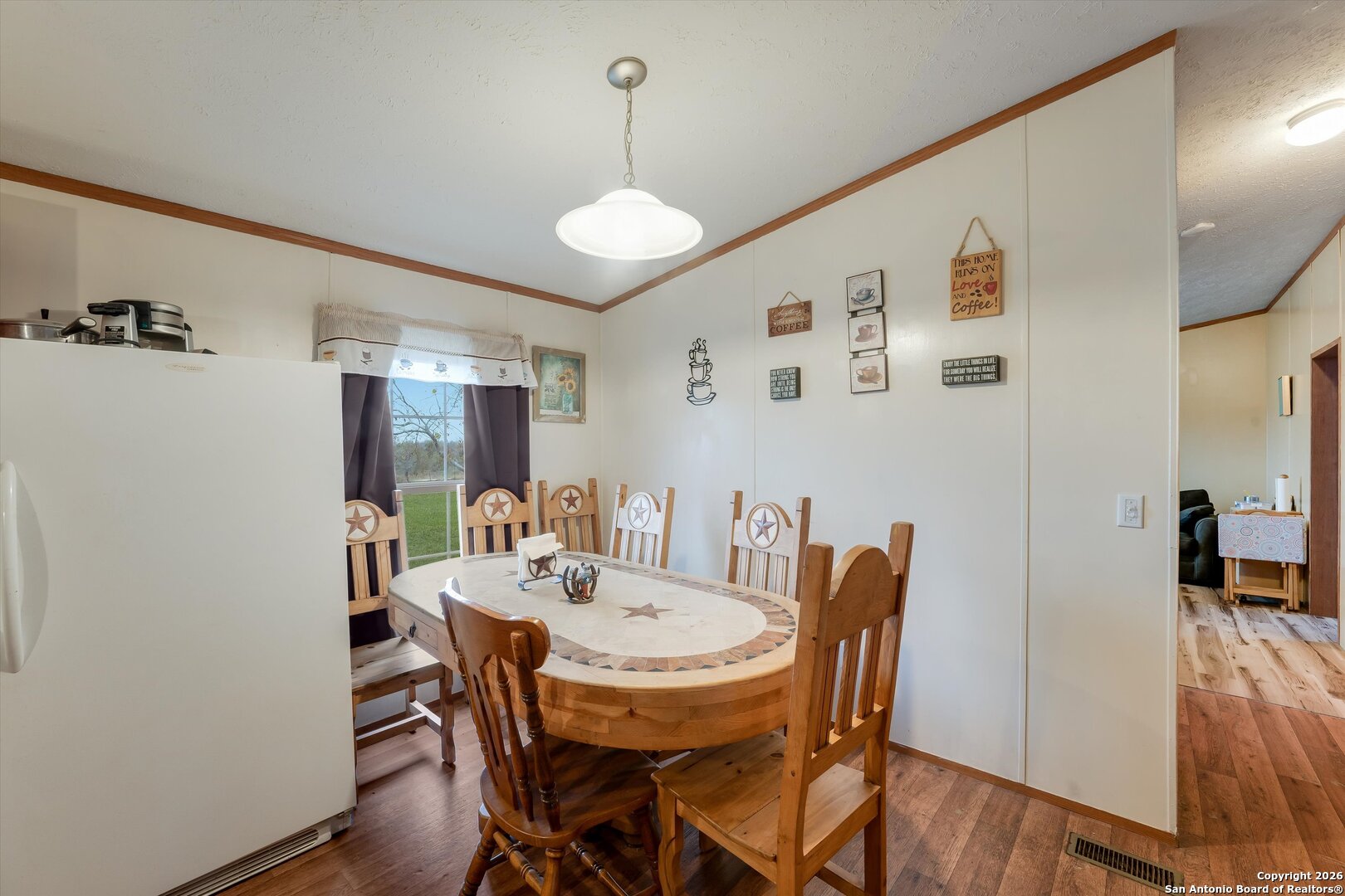 2760 Pioneer Road Seguin, TX 78155 - Photo 14 of 31 a view of a dining room with furniture and wooden floor