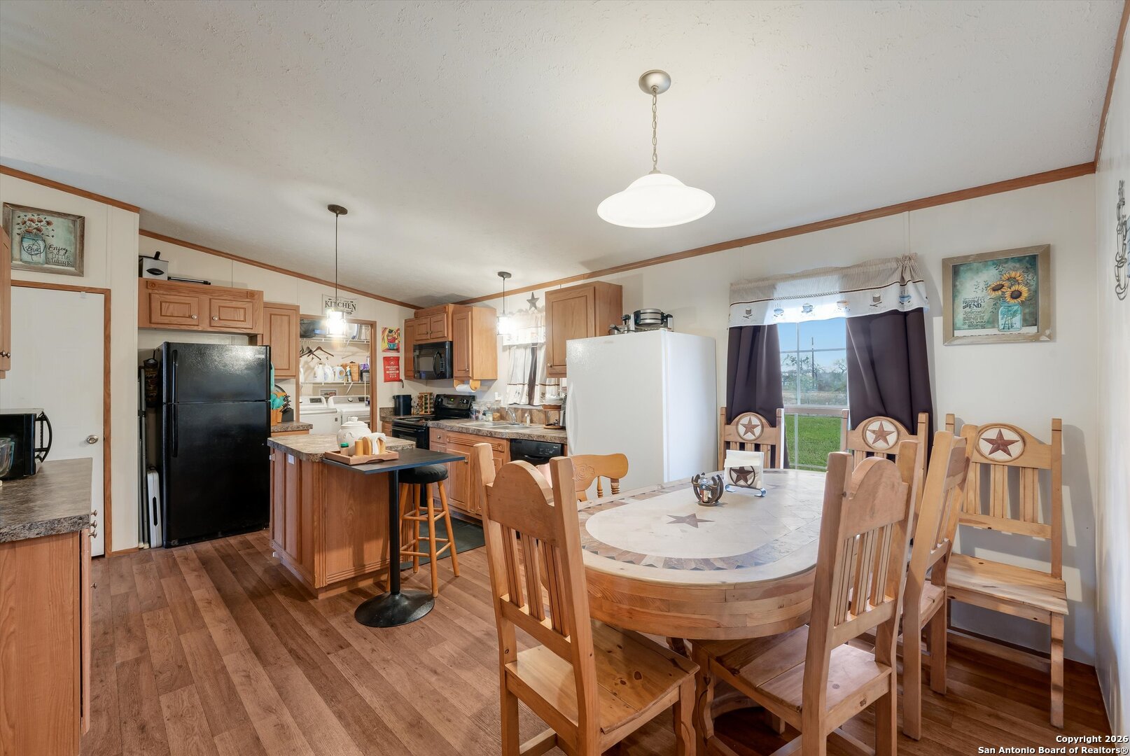 2760 Pioneer Road Seguin, TX 78155 - Photo 15 of 31 a dining room with furniture a chandelier and wooden floor