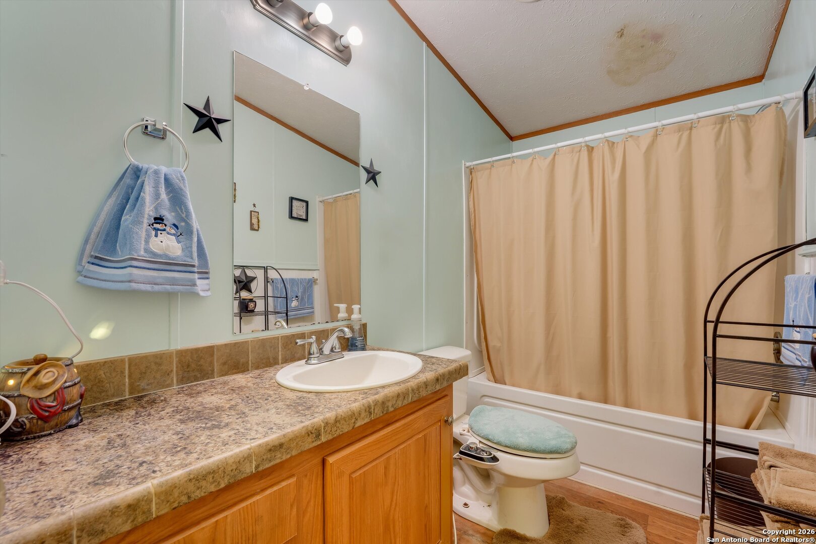 2760 Pioneer Road Seguin, TX 78155 - Photo 26 of 31 a bathroom with a granite countertop sink toilet and shower