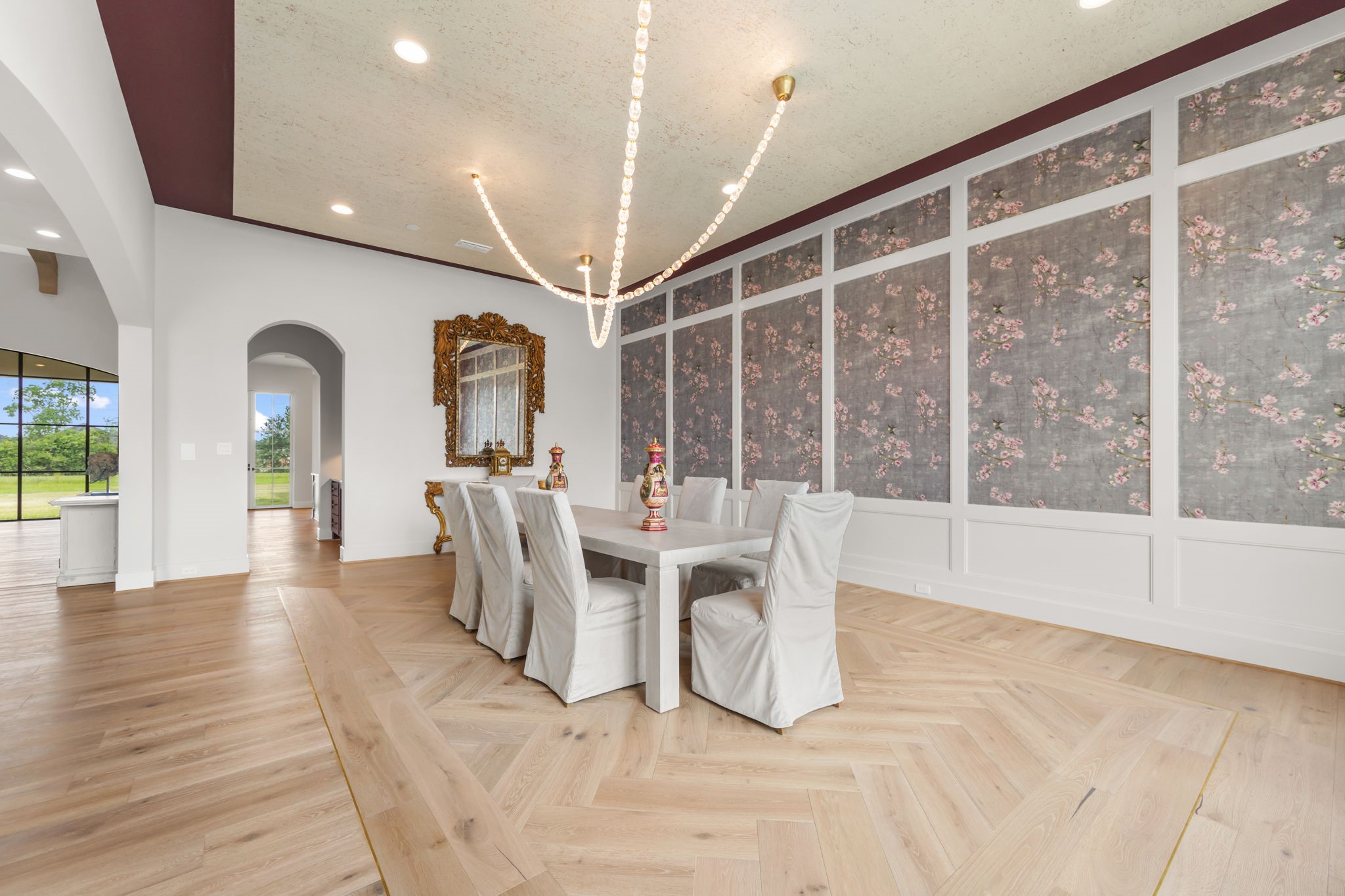 4233 Two Gun Way Katy, TX 77494 - Photo 7 of 47 Another view of formal dining room with unique rug design in hardwood floors framed by gold band which complement the crystal and gold accented light fixture.