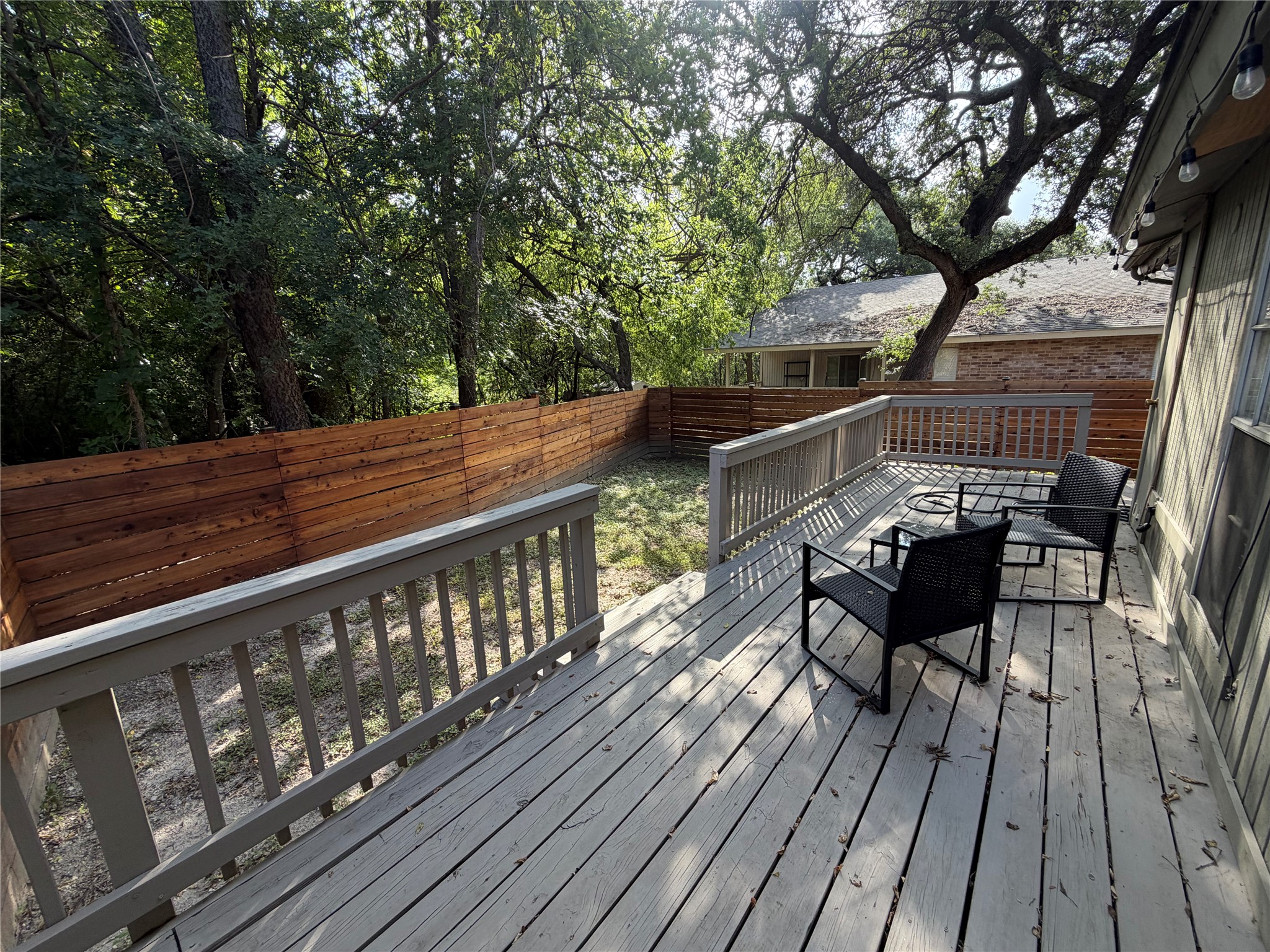 1400 Vista Ridge Cove, Unit B Austin, TX 78754 - Photo 25 of 25 A spacious wooden deck extends to a private, fenced yard, offering a tranquil outdoor retreat.