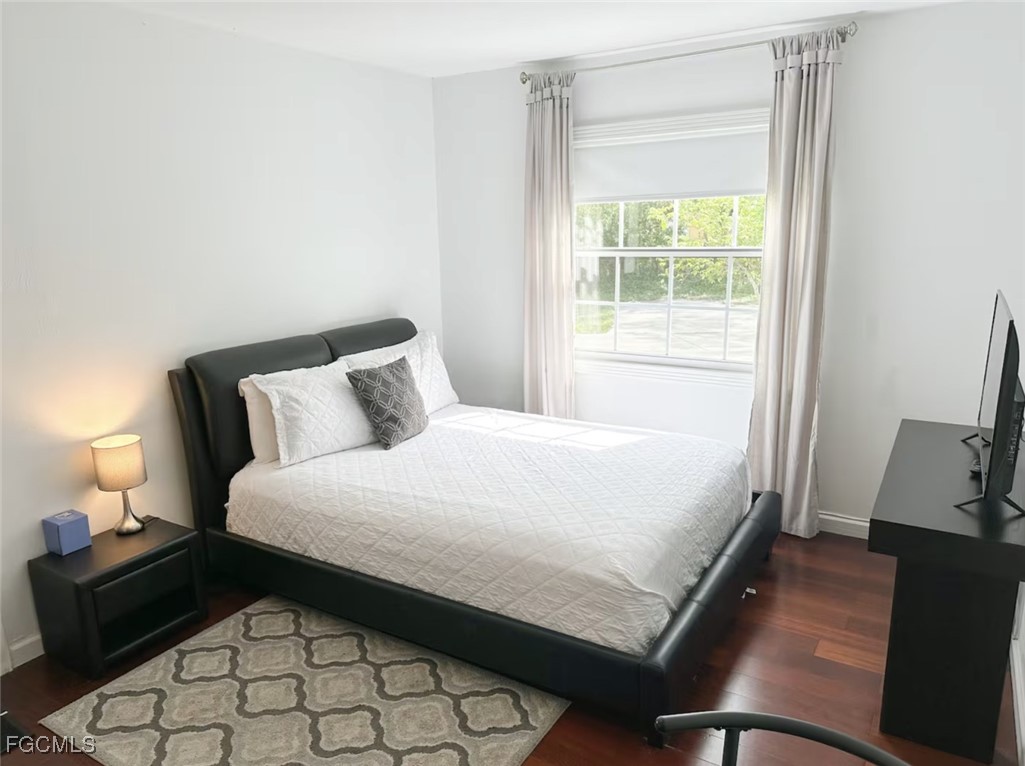 6343 Mark Lane Fort Myers, FL 33966 - Photo 16 of 37 a bedroom with a bed window and a television