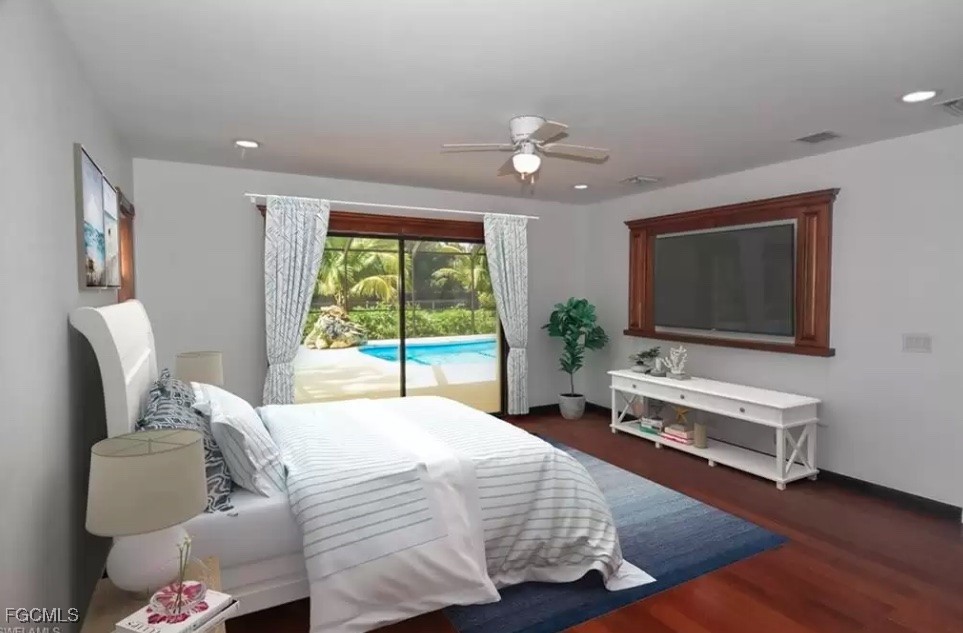 6343 Mark Lane Fort Myers, FL 33966 - Photo 29 of 37 a bedroom with a bed and large windows