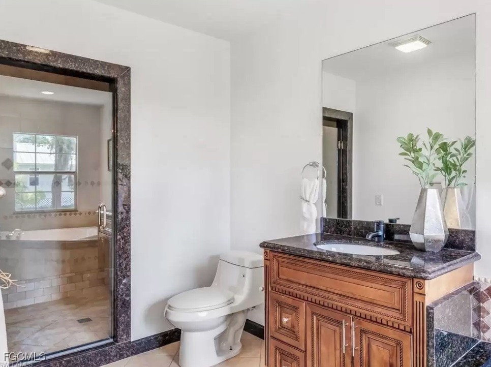 6343 Mark Lane Fort Myers, FL 33966 - Photo 31 of 37 a bathroom with a granite countertop sink a toilet a mirror and shower