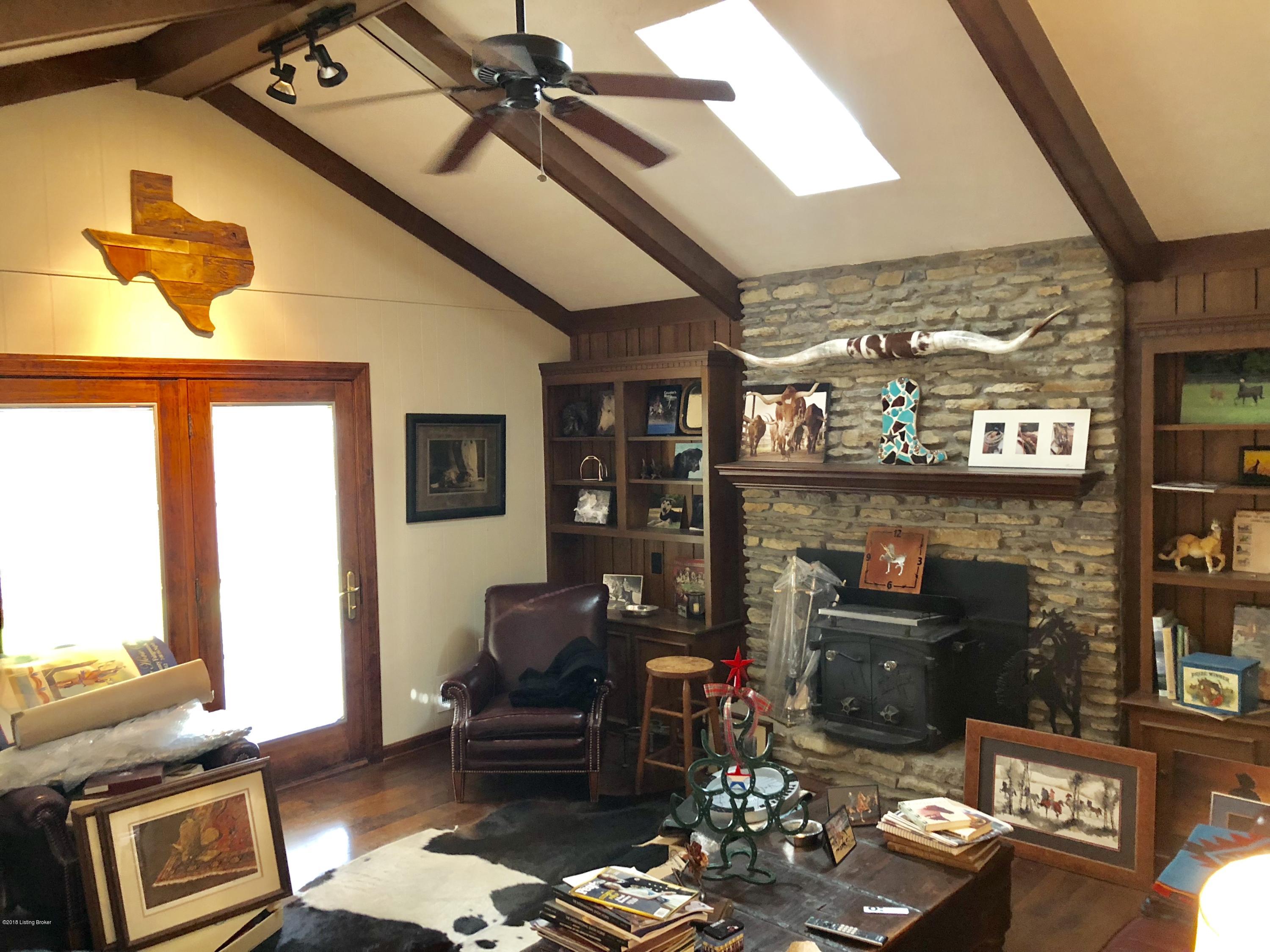 330 Colt Run Road Simpsonville, KY 40067 - Photo 6 of 15 Family room, cathedral,skylight, stone wood or wood stove burning fireplace, bookshelves, lead out to glassed in sunroom and pool areas