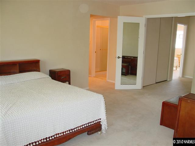 1451 Foster Drive Reno, NV 89509 - Photo 7 of 13 a bedroom with a bed and a couch