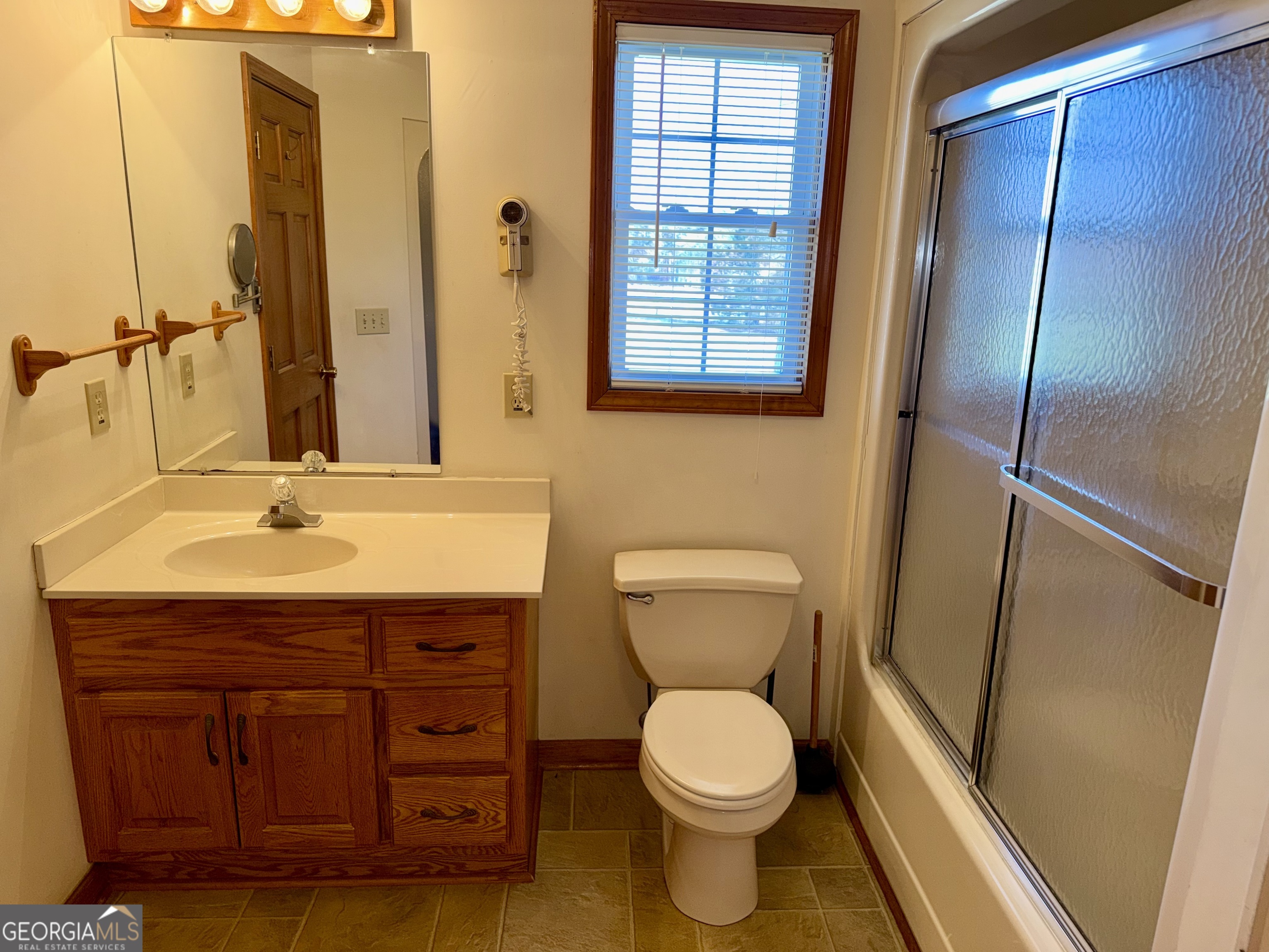 494 Broad Street Bowman, GA 30624 - Photo 35 of 65 a bathroom with a sink a toilet and shower