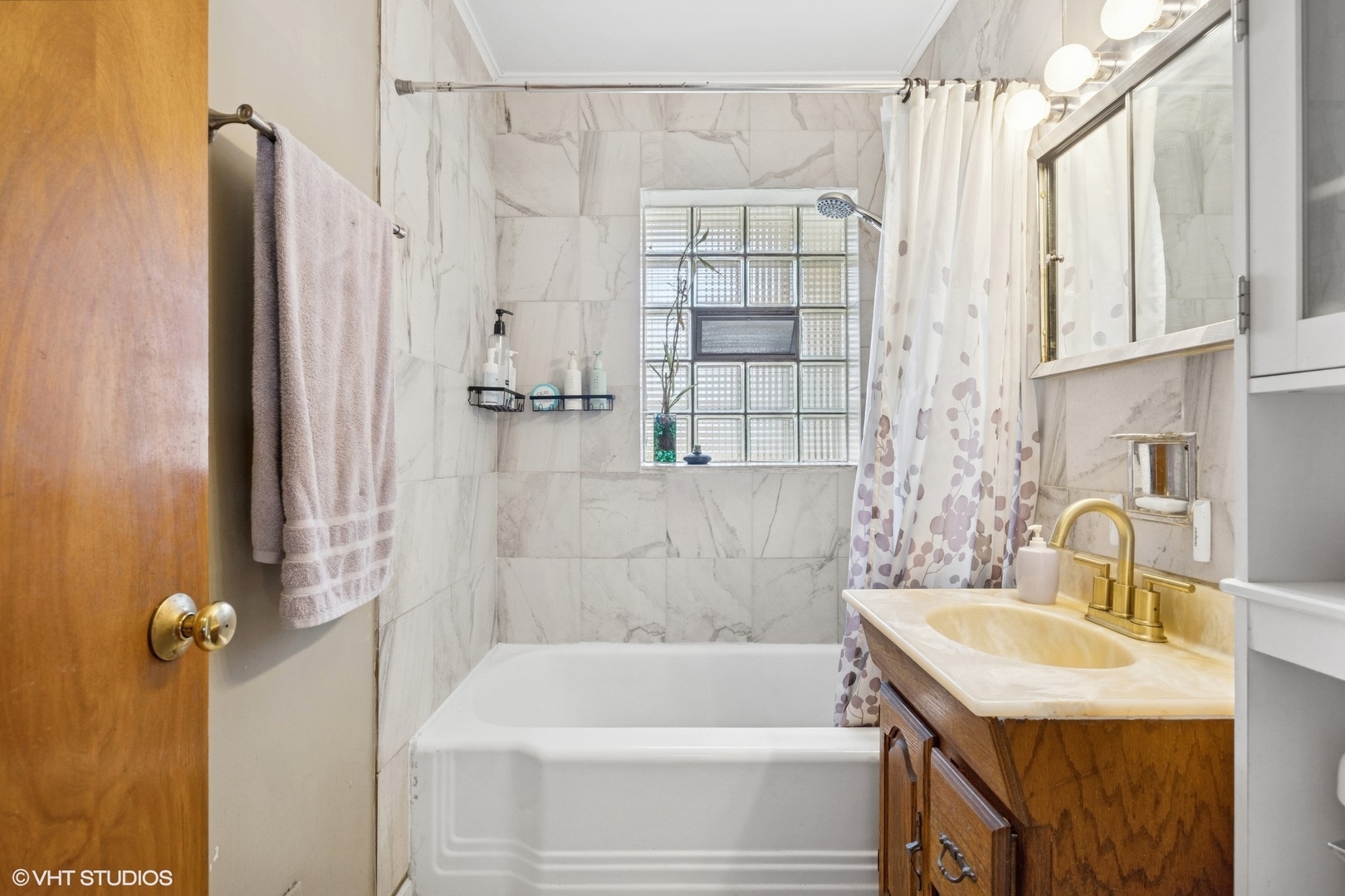 1315 Webster Lane Des Plaines, IL 60018 - Photo 8 of 18 a bathroom with a sink a bathtub and shower