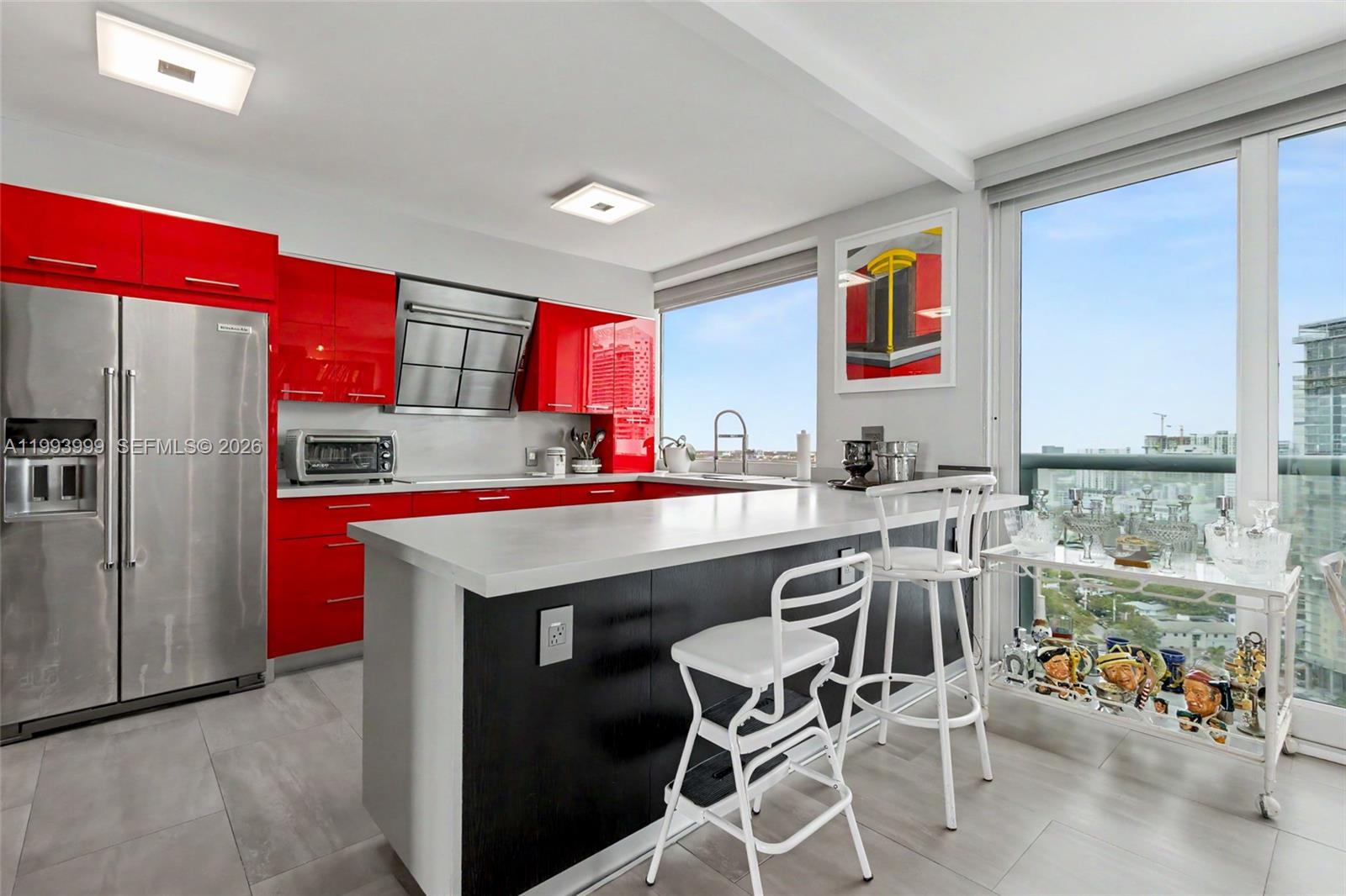 1541 Brickell Avenue, Unit B2904 Miami, FL 33129 - Photo 12 of 47 a kitchen with stainless steel appliances granite countertop a table chairs in it and wooden floors