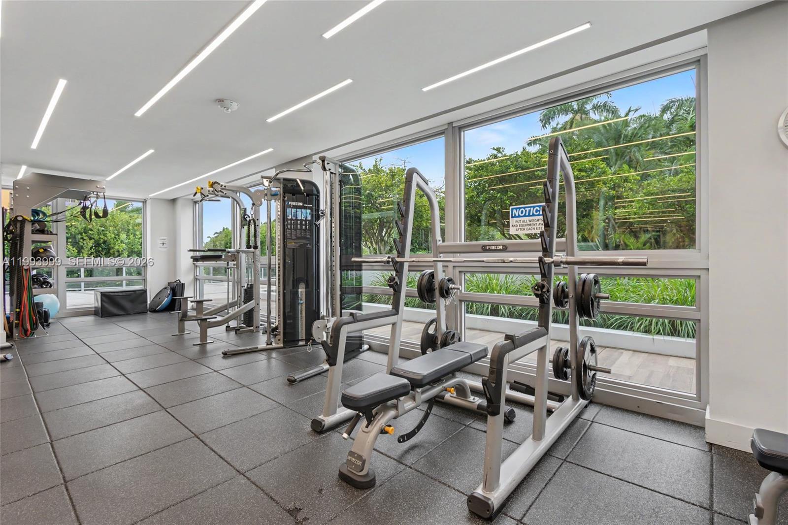 1541 Brickell Avenue, Unit B2904 Miami, FL 33129 - Photo 37 of 47 a view of a room with gym equipment and floor to ceiling window