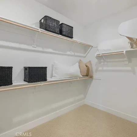 a bedroom with a bed and a mirror