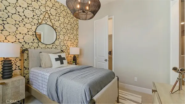 a bedroom with a bed and a chandelier