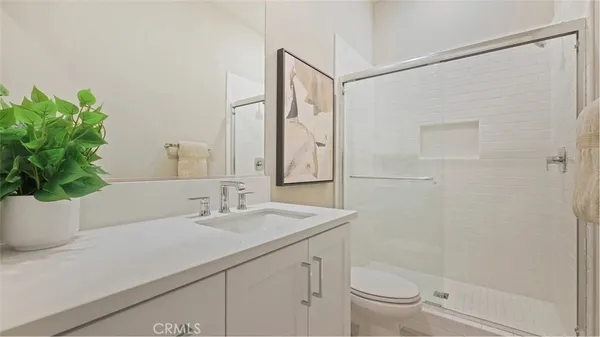 a bedroom with bed and a mirror