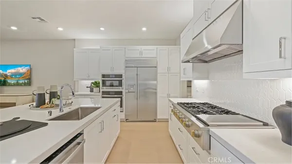 a kitchen that has a sink and a stove