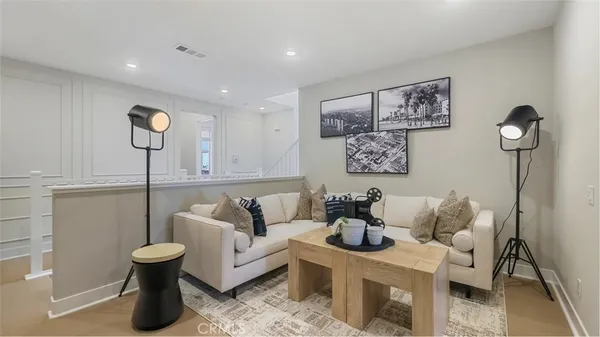 a living room with furniture and a potted plant