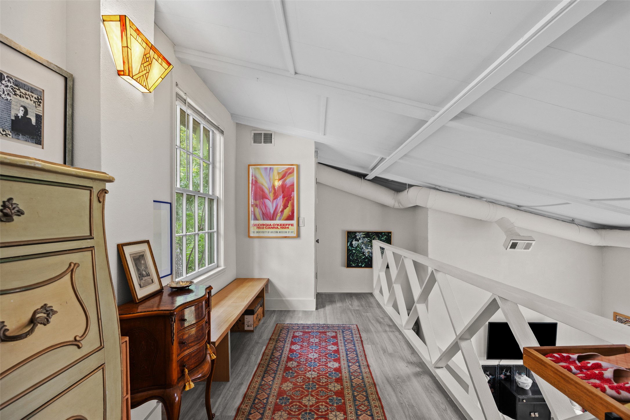 3302 Cherrywood Road Austin, TX 78722 - Photo 6 of 26 A well-lit loft space features sloped ceilings and abundant natural light. Can easily serve as a second living space or be converted to a second bedroom.