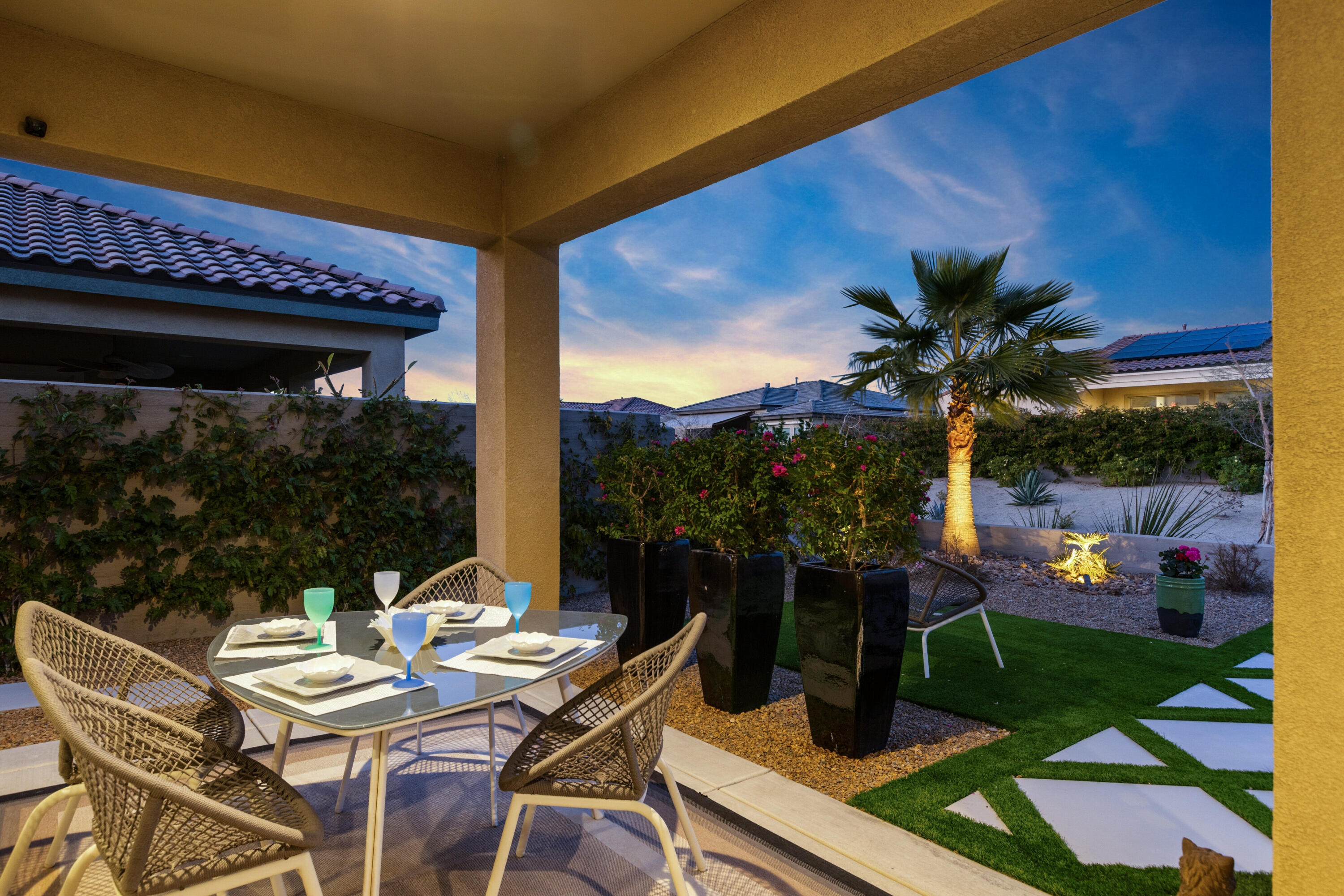 36 Chianti Rancho Mirage, CA 92270 - Photo 25 of 63 a view of a patio with table and chairs potted plants and floor to ceiling window