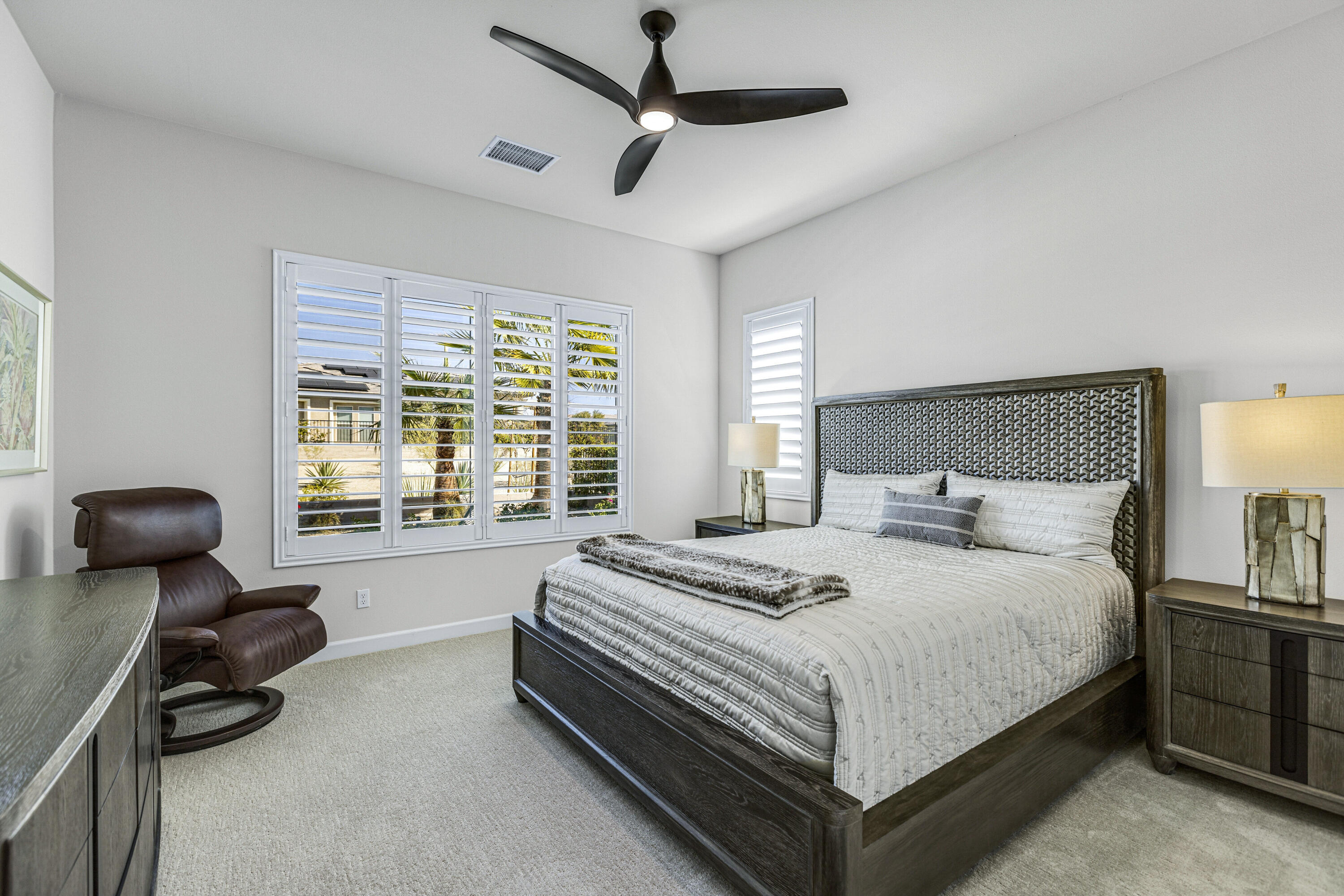 36 Chianti Rancho Mirage, CA 92270 - Photo 31 of 63 a bedroom with a bed and a chandelier