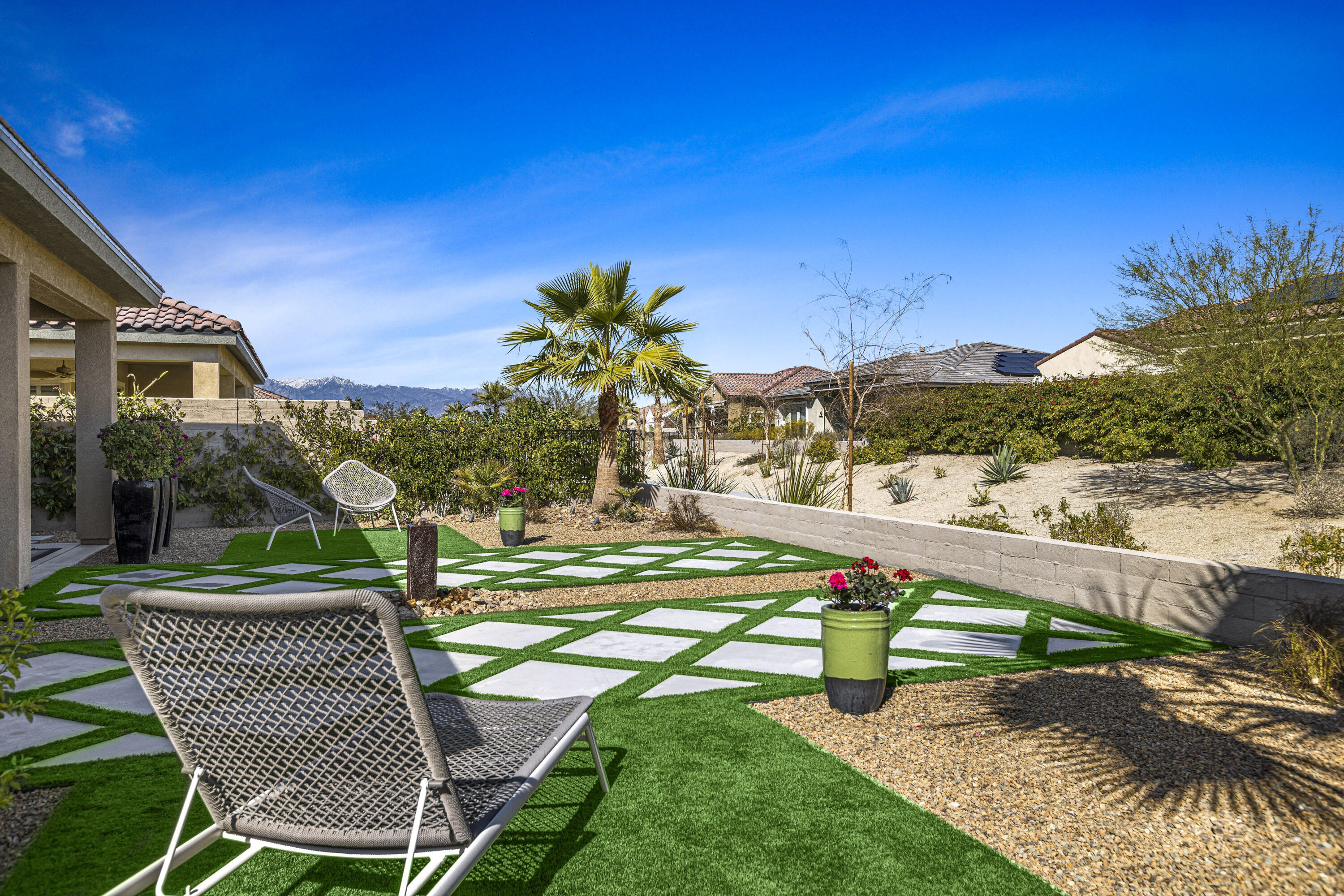 36 Chianti Rancho Mirage, CA 92270 - Photo 50 of 63 a view of a chair and tables in the backyard