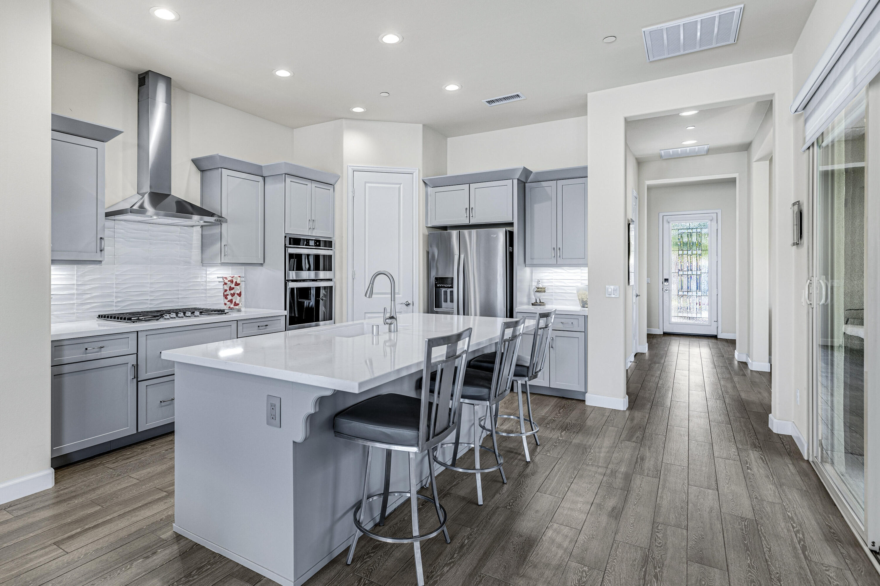 36 Chianti Rancho Mirage, CA 92270 - Photo 7 of 63 a kitchen with a table chairs refrigerator and cabinets