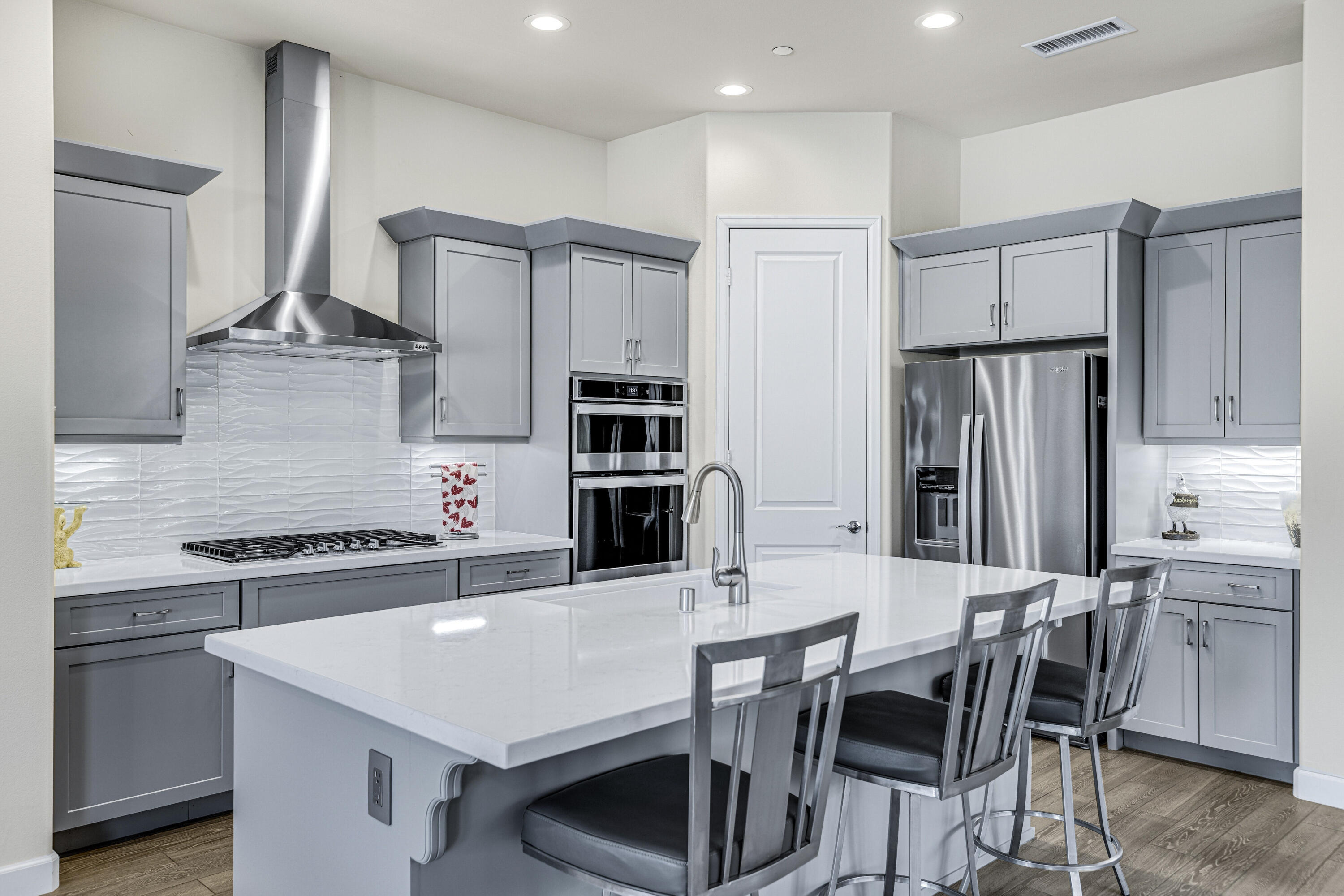 36 Chianti Rancho Mirage, CA 92270 - Photo 8 of 63 a kitchen with stainless steel appliances a dining table chairs refrigerator and cabinets