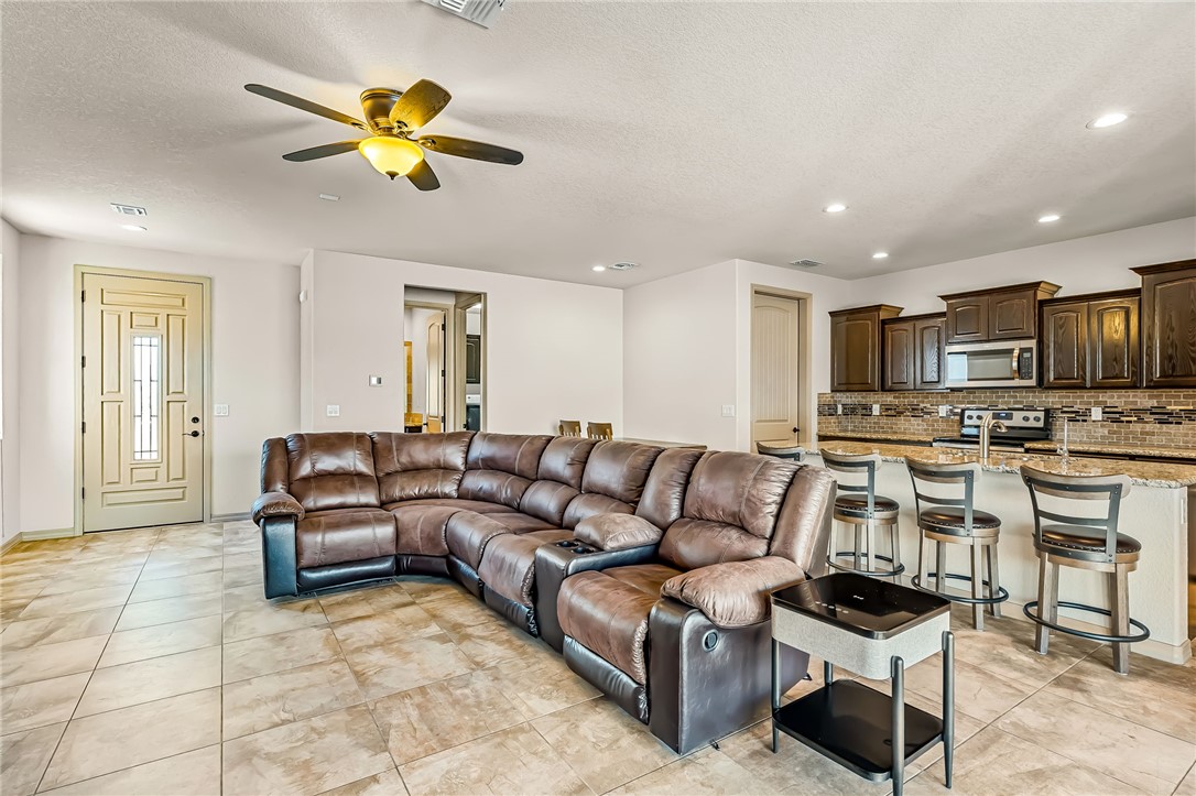 2605 Nez Perce Road Fort Mohave, AZ 86426 - Photo 6 of 53 Living room featuring a textured ceiling, a ceiling fan, recessed lighting, and light tile patterned floors
