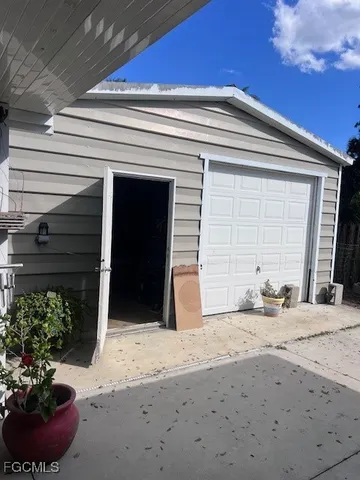 a view of a backyard of a house with potted plants