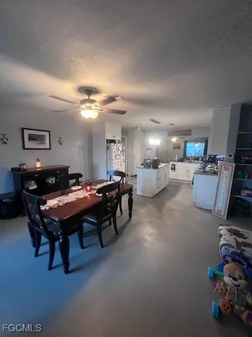 a room with furniture pool table and a flat screen tv