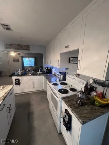 a kitchen with stainless steel appliances a sink stove and cabinets