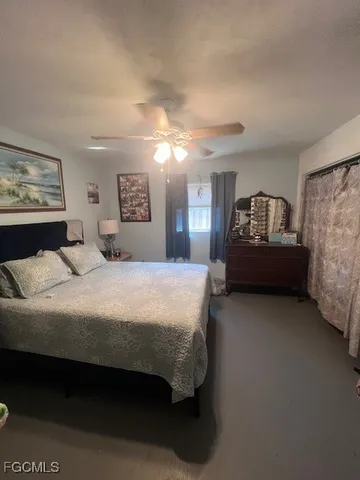 a bedroom with bed and window