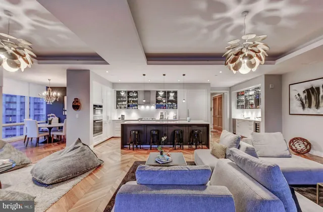 a living room with fireplace furniture and a chandelier