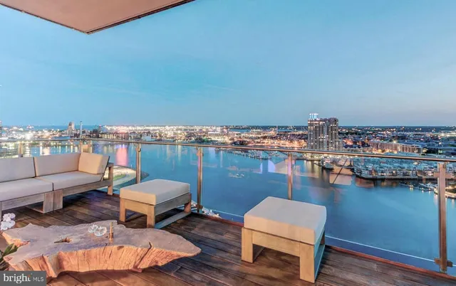 a balcony with chairs and a table