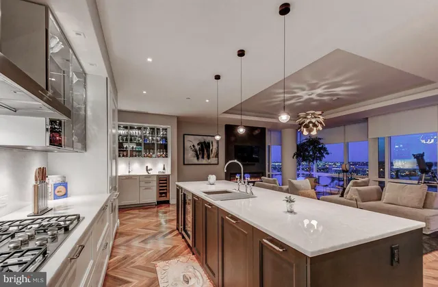 a kitchen with stainless steel appliances a sink stove and cabinets