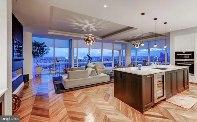 a large kitchen with stainless steel appliances kitchen island granite countertop a sink and a stove