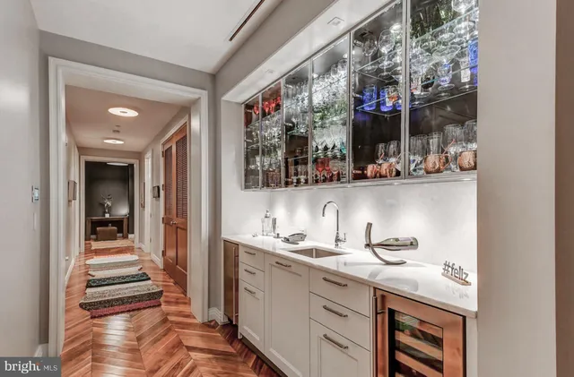 a view of a dining room with furniture a chandelier and wooden floor