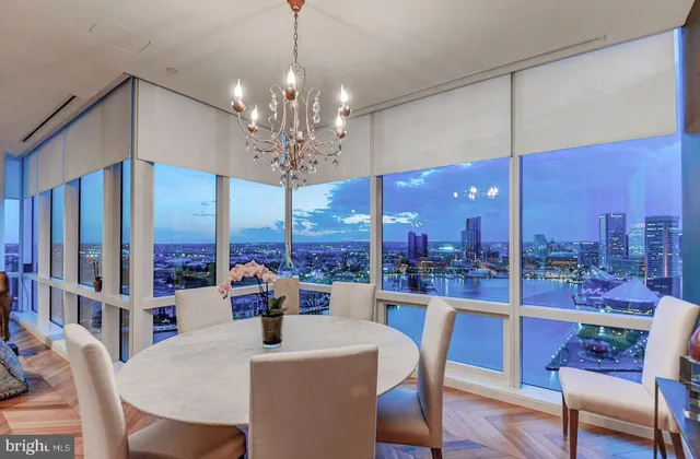 a view of a hallway with wooden floor and a bathroom