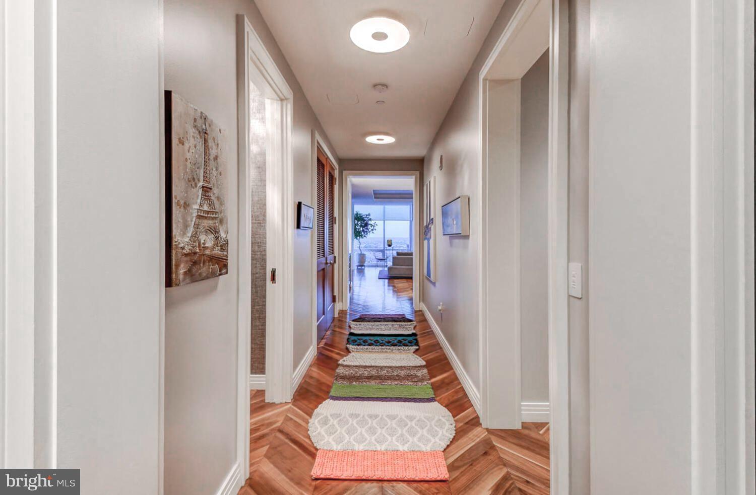 300 International Drive, Unit 2301 Baltimore, MD 21202 - Photo 27 of 37 a view of a hallway with wooden floor and a bathroom