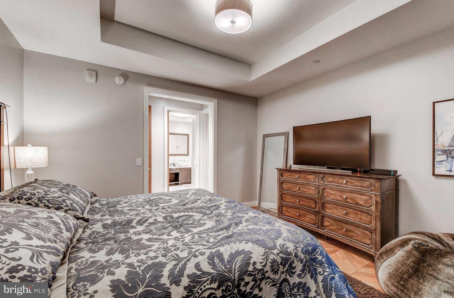 300 International Drive, Unit 2301 Baltimore, MD 21202 - Photo 29 of 37 a bedroom with a bed and a flat screen tv