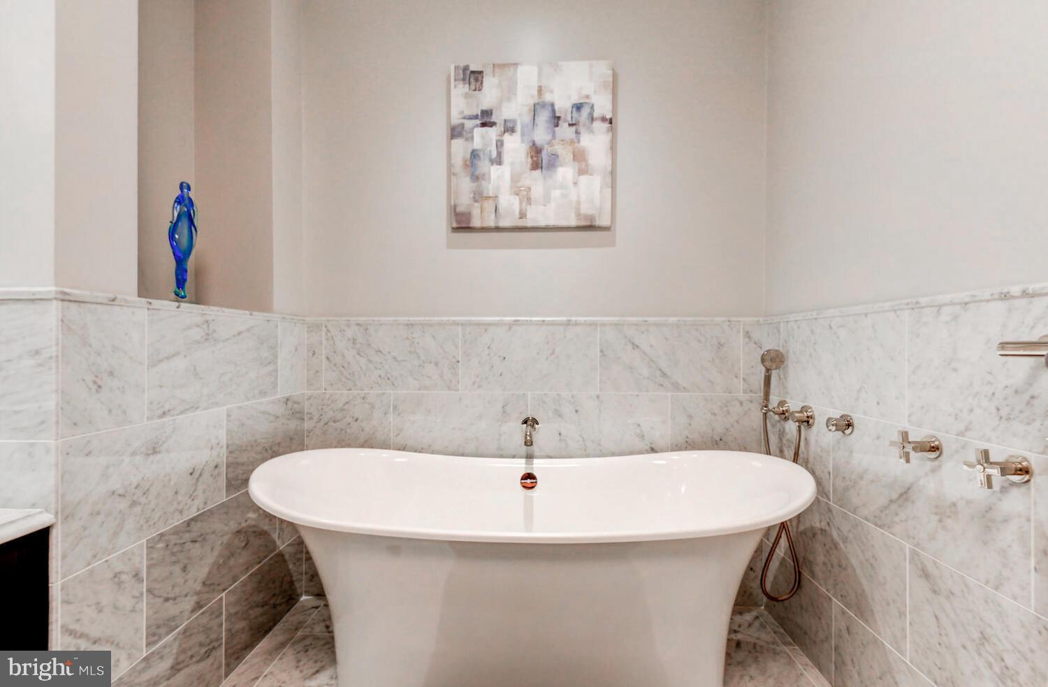 300 International Drive, Unit 2301 Baltimore, MD 21202 - Photo 32 of 37 a bathroom with a sink and mirror