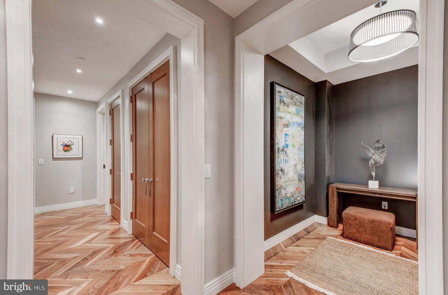 300 International Drive, Unit 2301 Baltimore, MD 21202 - Photo 36 of 37 a bedroom with a bed and a mirror