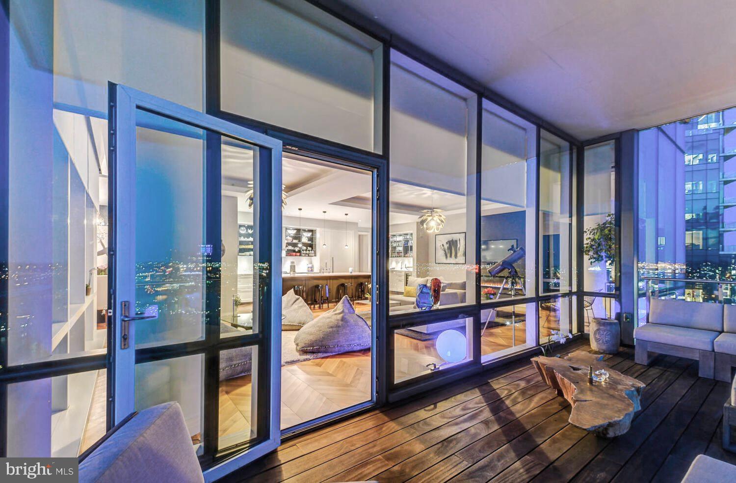 300 International Drive, Unit 2301 Baltimore, MD 21202 - Photo 5 of 37 a living room with furniture and a large window