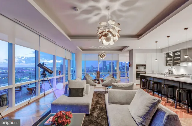 a living room with furniture and a chandelier