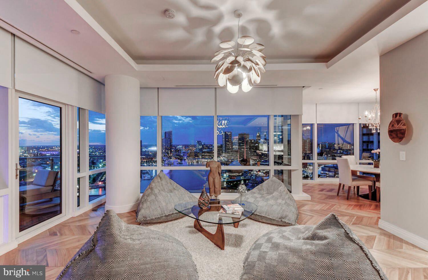 300 International Drive, Unit 2301 Baltimore, MD 21202 - Photo 9 of 37 a living room with furniture a chandelier and a dining table