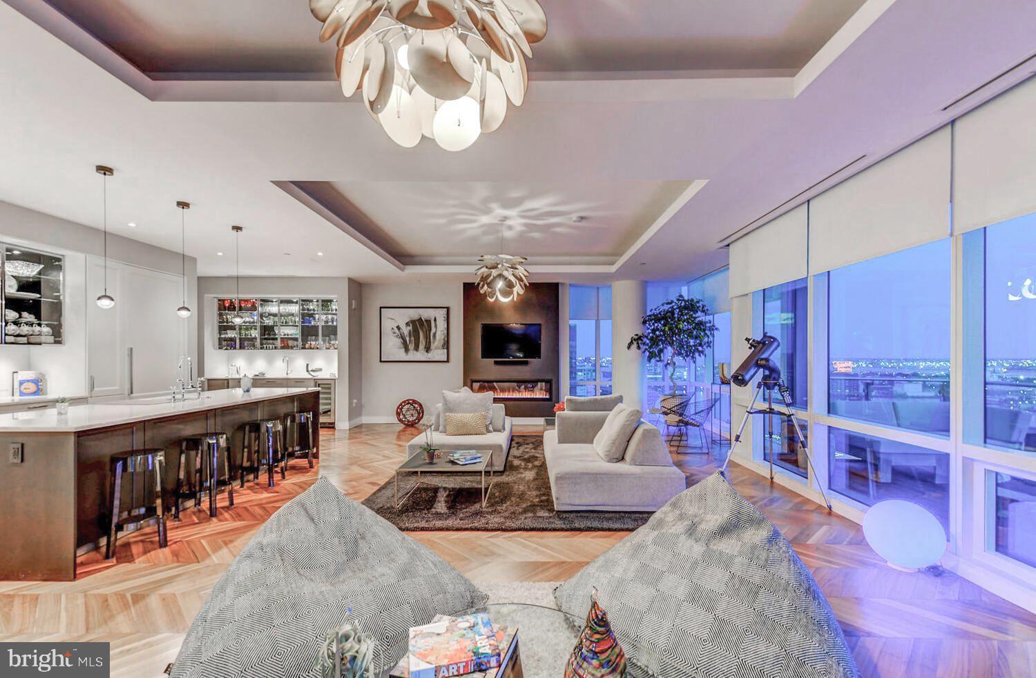 300 International Drive, Unit 2301 Baltimore, MD 21202 - Photo 10 of 37 a living room with lots of furniture and a chandelier