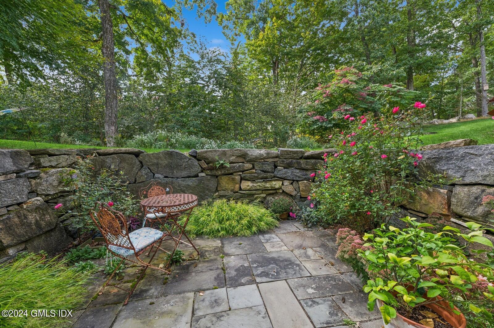 155 Cat Rock Road Cos Cob, CT 06807 - Photo 25 of 29 a backyard of a house with a yard and outdoor seating