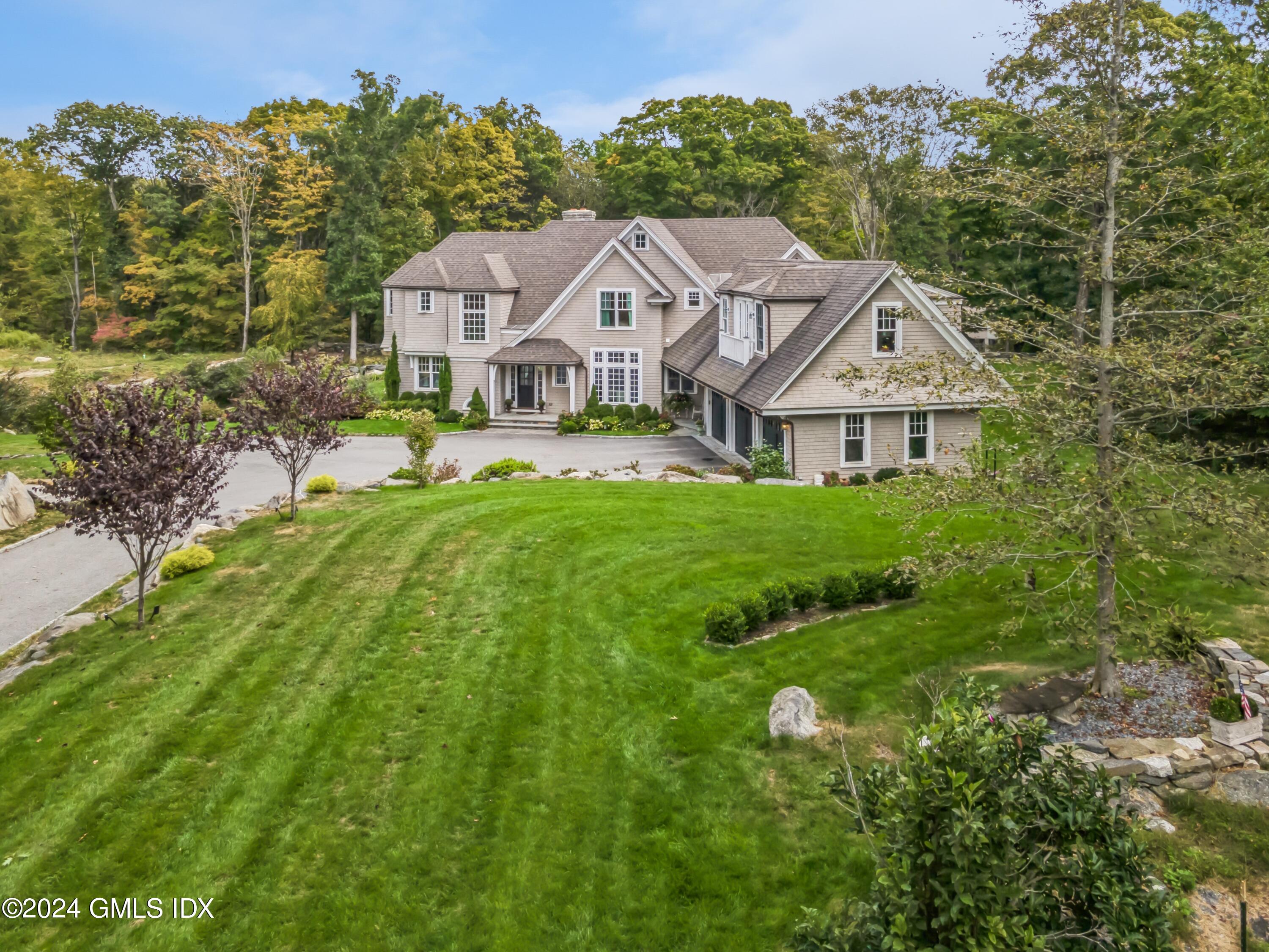 155 Cat Rock Road Cos Cob, CT 06807 - Photo 29 of 29 a aerial view of a house with a big yard and large trees